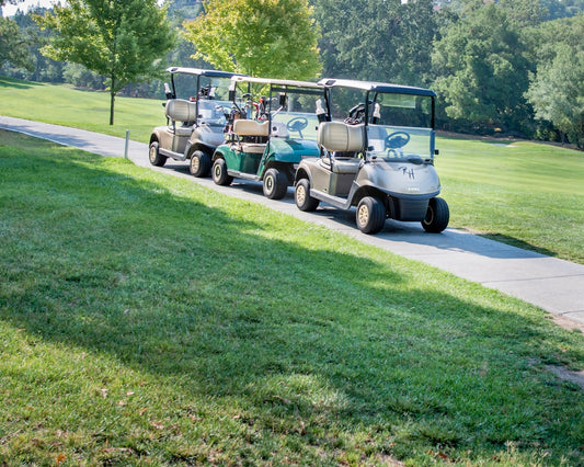 white and black golf cart on green grass field during daytime