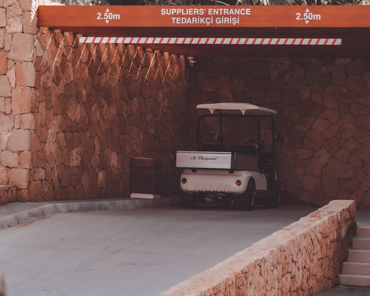 a golf cart parked in front of a stone wall